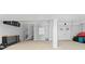 Spacious garage with spiral staircase, workbench, and ample storage at 17706 1St E St, Redington Shores, FL 33708