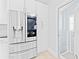 Stainless steel refrigerator in a modern white kitchen at 17706 1St E St, Redington Shores, FL 33708