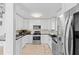 Bright kitchen with stainless steel appliances and white cabinets at 17706 1St E St, Redington Shores, FL 33708