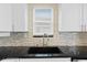 Modern kitchen sink with a sleek faucet and stylish backsplash at 17706 1St E St, Redington Shores, FL 33708