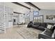 Open living room with vaulted ceiling, spiral staircase, and black sectional sofa at 17706 1St E St, Redington Shores, FL 33708