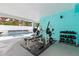 Outdoor gym area with weight bench, dumbbells and kettlebell at 17706 1St E St, Redington Shores, FL 33708