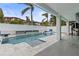 Inviting pool area with spacious patio, lounge chairs, and water features at 17706 1St E St, Redington Shores, FL 33708