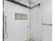 Clean shower with subway tile and pebble accents at 17706 1St E St, Redington Shores, FL 33708