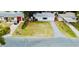 Aerial view of a single-story home with a spacious yard and driveway at 1833 Knollwood Dr, Holiday, FL 34690
