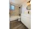 Renovated bathroom, featuring a white vanity, tile surround, and a new toilet at 1833 Knollwood Dr, Holiday, FL 34690