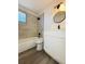 Updated bathroom with modern vanity, tile shower/tub combo, and new flooring at 1833 Knollwood Dr, Holiday, FL 34690