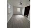 Bright bedroom with ceiling fan, large closet, and wood-look flooring at 1833 Knollwood Dr, Holiday, FL 34690
