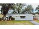 Charming single story home with a white exterior and mature landscaping at 1833 Knollwood Dr, Holiday, FL 34690