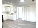 Remodeled kitchen with white cabinets, new flooring, and stainless steel appliances at 1833 Knollwood Dr, Holiday, FL 34690