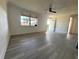 Living room featuring a window, door, and wood-look floors at 1833 Knollwood Dr, Holiday, FL 34690