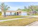Single-story home with a two-car garage and landscaped yard at 2109 Elmwood Ct, Plant City, FL 33563