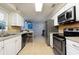 Bright kitchen, stainless steel appliances, and white cabinets at 2109 Elmwood Ct, Plant City, FL 33563