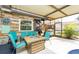 Covered patio with fire pit, seating, and grilling area at 2109 Elmwood Ct, Plant City, FL 33563