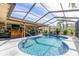 Inviting kidney-shaped pool and spa with a screened enclosure at 2109 Elmwood Ct, Plant City, FL 33563