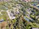 Aerial view of community featuring tennis court and pool at 2912 Star Apple Ct, Palm Harbor, FL 34684