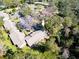 Aerial view of condo building nestled amongst lush trees and parking area at 2912 Star Apple Ct, Palm Harbor, FL 34684