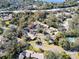 Wide aerial view of community near road and water, showing buildings and landscape at 2912 Star Apple Ct, Palm Harbor, FL 34684