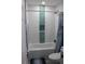 Updated bathroom with wave patterned tile and teal accents at 2912 Star Apple Ct, Palm Harbor, FL 34684