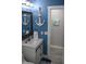 Bathroom with white vanity, blue walls, and anchor decor at 2912 Star Apple Ct, Palm Harbor, FL 34684