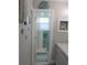 Bathroom with walk-in shower and decorative tile at 2912 Star Apple Ct, Palm Harbor, FL 34684