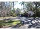 Community entrance with gatehouse and flag at 2912 Star Apple Ct, Palm Harbor, FL 34684