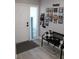 Bright entryway with bench, photo display, and grey floors at 2912 Star Apple Ct, Palm Harbor, FL 34684