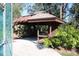 Wooden gazebo with seating, near fence at 2912 Star Apple Ct, Palm Harbor, FL 34684