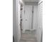 Clean hallway with light gray flooring and white doors at 2912 Star Apple Ct, Palm Harbor, FL 34684