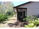Side view of house with screened porch at 2912 Star Apple Ct, Palm Harbor, FL 34684