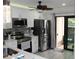 Modern kitchen featuring stainless steel appliances, white cabinets and easy access to the outdoors at 2912 Star Apple Ct, Palm Harbor, FL 34684