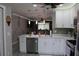 Open floor plan featuring a bright kitchen with an island and stainless steel appliances at 2912 Star Apple Ct, Palm Harbor, FL 34684