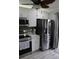 Bright kitchen with stainless steel appliances, white cabinets, and easy access to the outdoors at 2912 Star Apple Ct, Palm Harbor, FL 34684