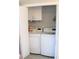 Convenient laundry room with washer, dryer, and built-in shelving at 2912 Star Apple Ct, Palm Harbor, FL 34684