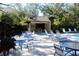 Community pool area with tables and chairs at 2912 Star Apple Ct, Palm Harbor, FL 34684