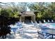 Community pool with patio tables and chairs at 2912 Star Apple Ct, Palm Harbor, FL 34684