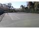 Tennis court surrounded by a fence at 2912 Star Apple Ct, Palm Harbor, FL 34684