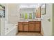 Main bathroom with double vanity and large mirror at 2932 Tanglewylde Dr, Land O Lakes, FL 34638