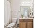 Clean bathroom with wood vanity, shower/tub combo and recessed shelving at 2932 Tanglewylde Dr, Land O Lakes, FL 34638