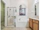 Bathroom boasts a double vanity, garden mural, and shower at 2932 Tanglewylde Dr, Land O Lakes, FL 34638