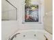 Relaxing bathroom with garden mural and jetted tub at 2932 Tanglewylde Dr, Land O Lakes, FL 34638