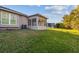 View of the home's exterior, highlighting the sunroom and landscaping at 2932 Tanglewylde Dr, Land O Lakes, FL 34638