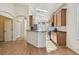 Open kitchen with breakfast bar and access to living room at 2932 Tanglewylde Dr, Land O Lakes, FL 34638