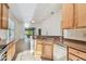 Kitchen with breakfast bar and view into living room at 2932 Tanglewylde Dr, Land O Lakes, FL 34638