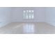 Empty bedroom with tile flooring and large window with shutters at 30826 Prout Ct, Wesley Chapel, FL 33543