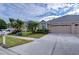 House exterior with a tan color scheme and palm trees at 30826 Prout Ct, Wesley Chapel, FL 33543