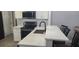 Modern kitchen with white cabinets, quartz countertops, and a breakfast bar at 3611 19Th N St, St Petersburg, FL 33713