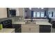 Eat-in kitchen with a breakfast bar, stainless steel appliances and view to the living room at 3611 19Th N St, St Petersburg, FL 33713
