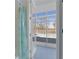 Bathroom with shower and view of the pool through glass doors at 456 Diamond Dr, Spring Hill, FL 34609