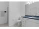 Bathroom with blue vanity, toilet and shower at 456 Diamond Dr, Spring Hill, FL 34609